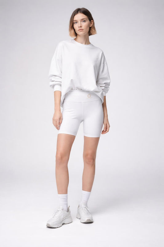 Full body view of the model wearing Women's White Workout Shorts — 'Civil Risk' Biker Shorts